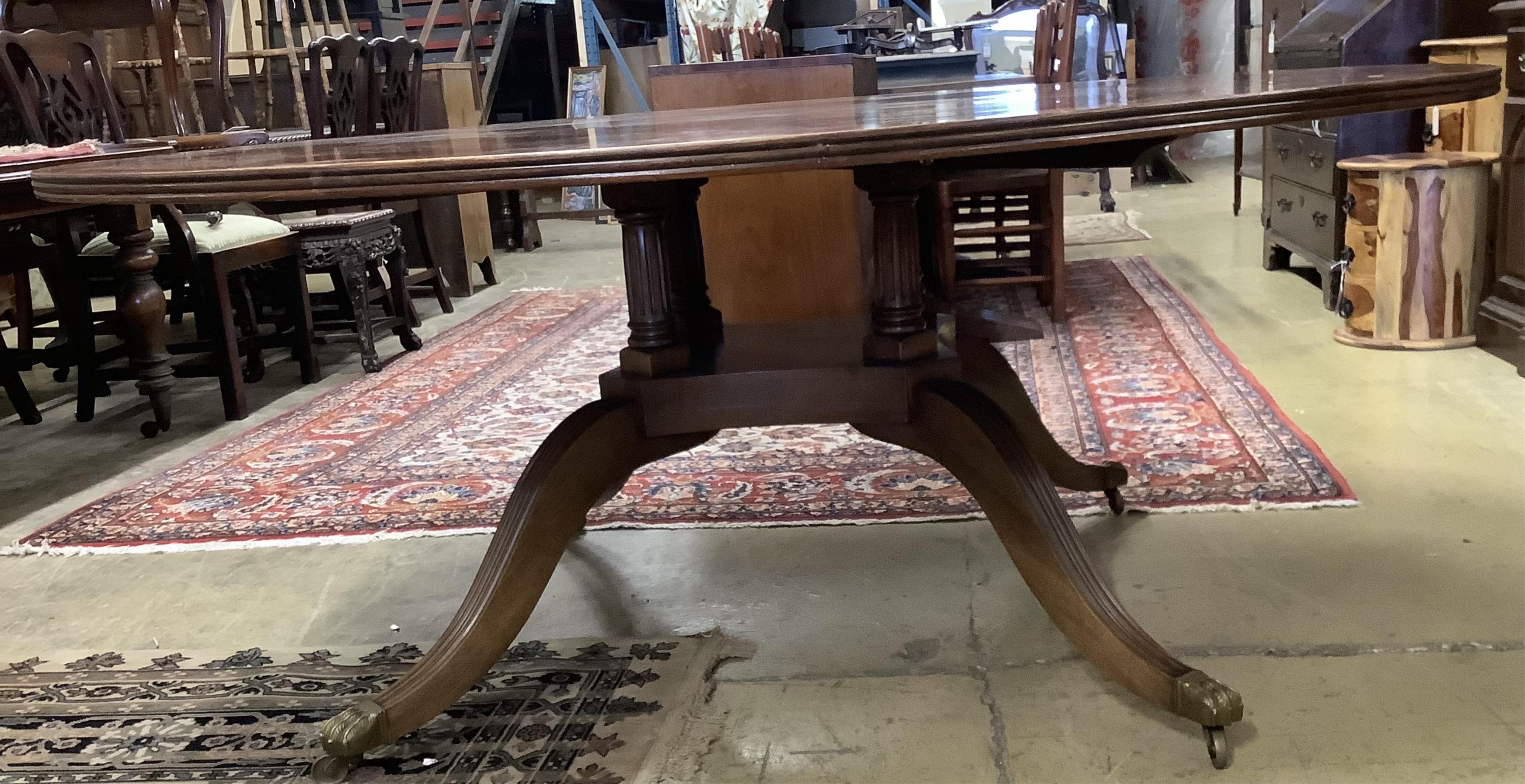 A reproduction George III style circular mahogany dining table, diameter 183cm, height 74cm